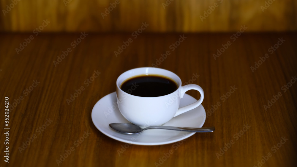 White small cup with saucer and cooled coffee White small cup with saucer and cooled coffee