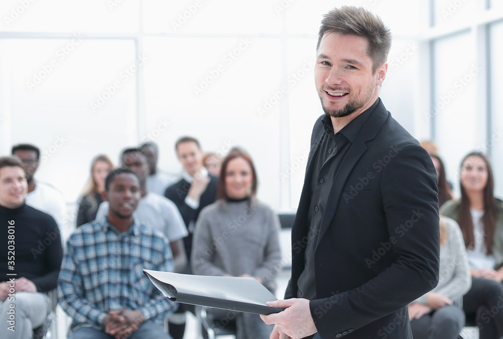 speaker with clipboard standing in the conference room speaker with clipboard standing in the conference room