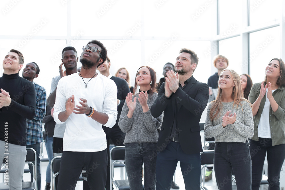 group of diverse young people applauding together. group of diverse young people applauding together.