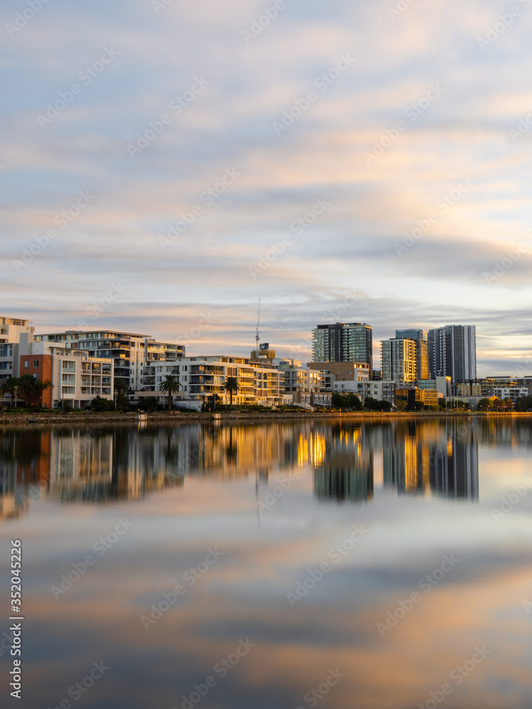 Morning view of building skyline at Wentworth Point, Sydney, Australia with reflection on the water. Morning view of building skyline at Wentworth Point, Sydney, Australia with reflection on the water.