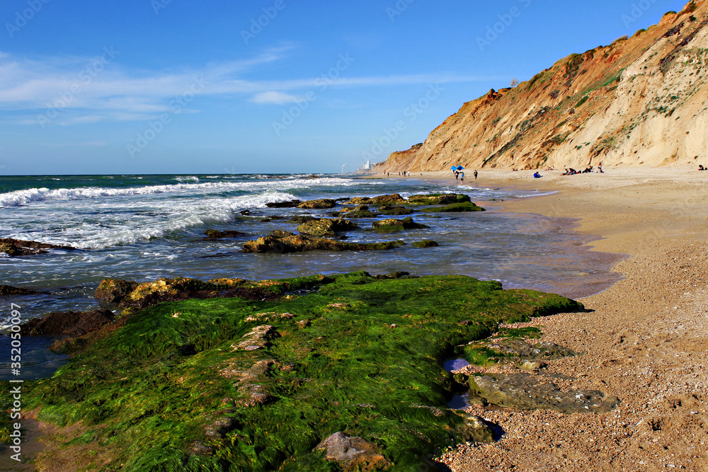 The Mediterranean coast in Israel. Beach on the rocky shore of the Mediterranean sea in natania in Israel.