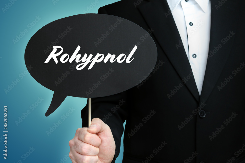 Rohypnol. Lawyer (Man) holds the sign of a speech bubble in his hand. Text on the label. Symbol of law, justice, judgement Rohypnol. Lawyer (Man) holds the sign of a speech bubble in his hand. Text on the label. Symbol of law, justice, judgement