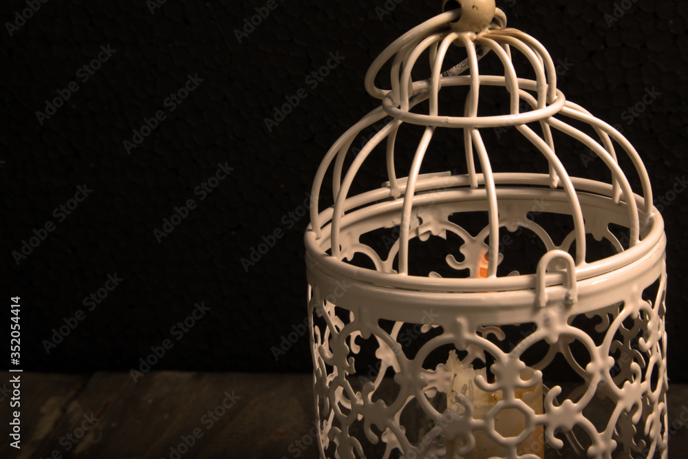 Close up shot of candle lantern on a rustic wooden table