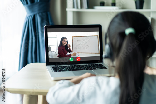 Asian girl student learning internet online class from school teacher