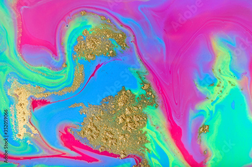 Fluorescent marble pattern with golden glitter. Blue, green and pink liquid background. Artwork abstract bright texture.