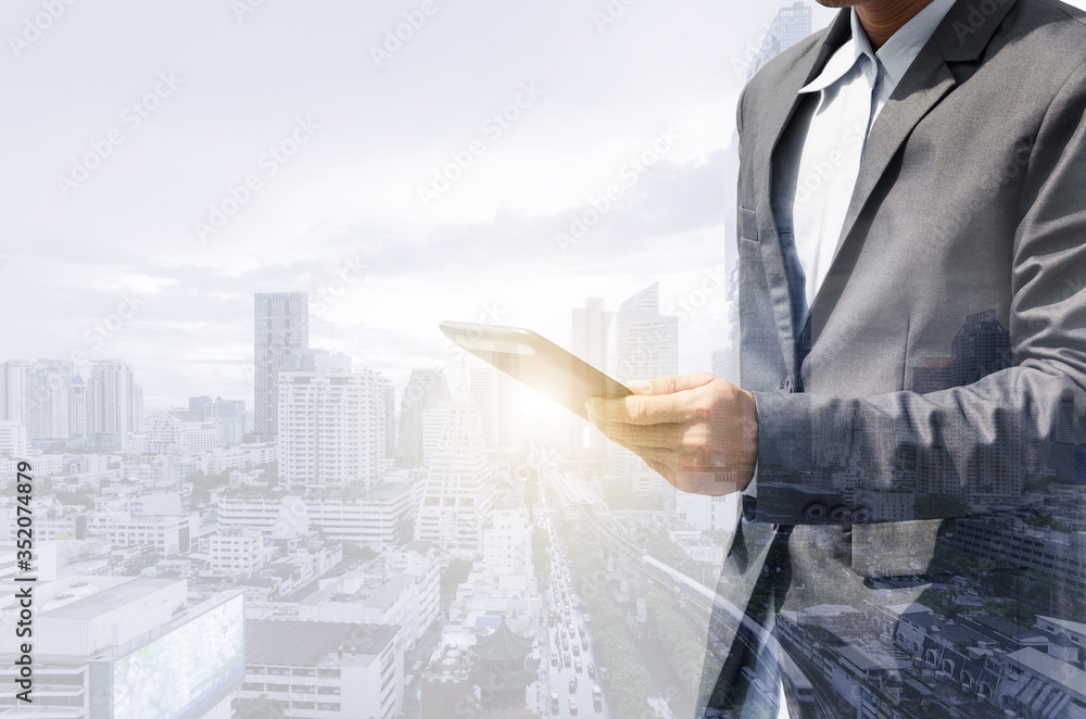 double exposure city and businessman using tablet smartphone searching with internet online networking. device mock up mobile phone texting communication connecting. double exposure city and businessman using tablet smartphone searching with internet online networking. device mock up mobile phone texting communication connecting.