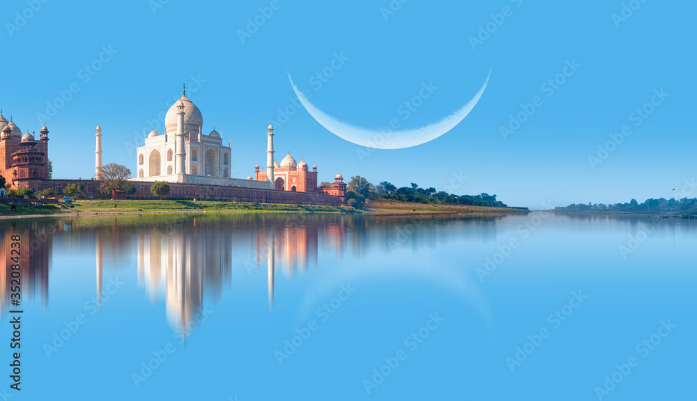 Taj Mahal mausoleum reflected in Yamuna river with crescent - Agra, Uttar Pradesh, India