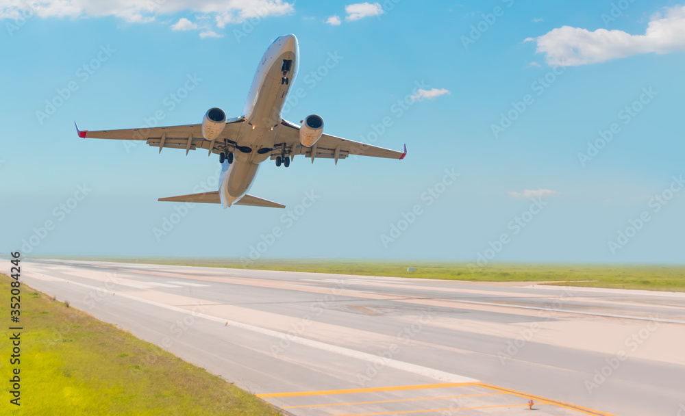 White Passenger plane fly up over take-off runway from airport White Passenger plane fly up over take-off runway from airport