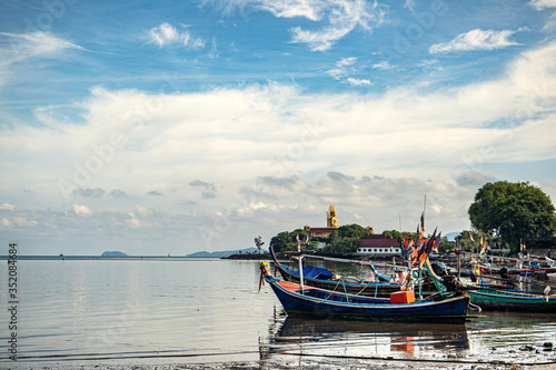 Fishing boats on the shore at low tide . Thailand