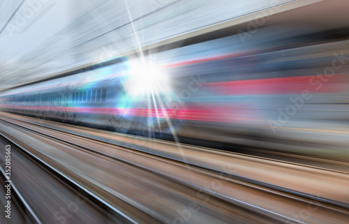 High speed train runs on rail tracks . Train in motion 