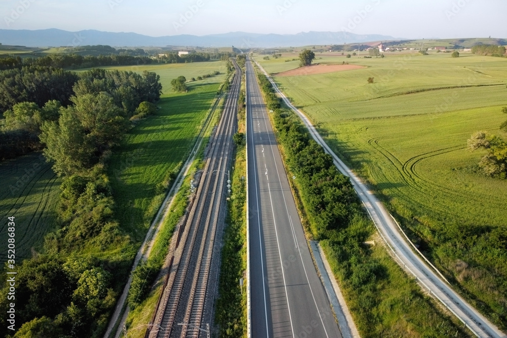 Aerial view, railway and road in rural landscape .