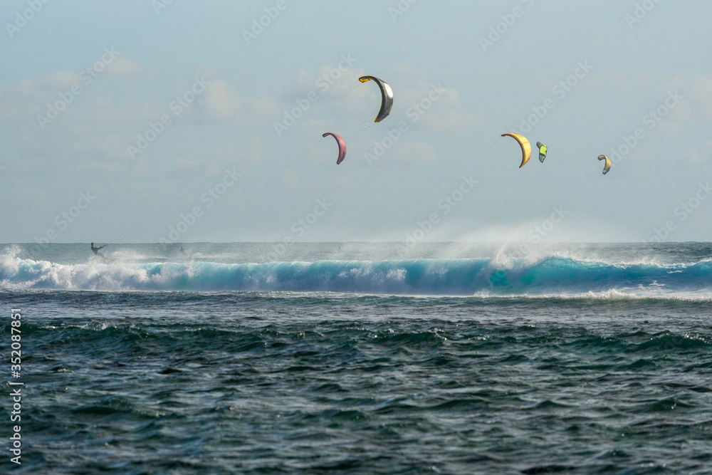 Colorful kites against a background of huge waves of the Indian Ocean. Mauritius Island Colorful kites against a background of huge waves of the Indian Ocean. Mauritius Island