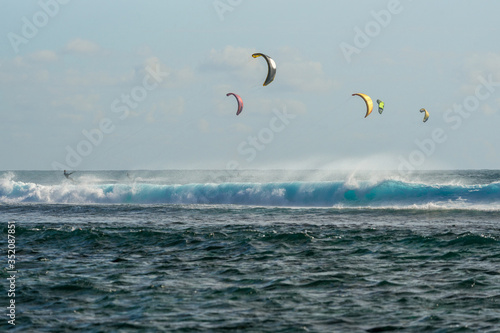 Colorful kites against a background of huge waves of the Indian Ocean. Mauritius Island