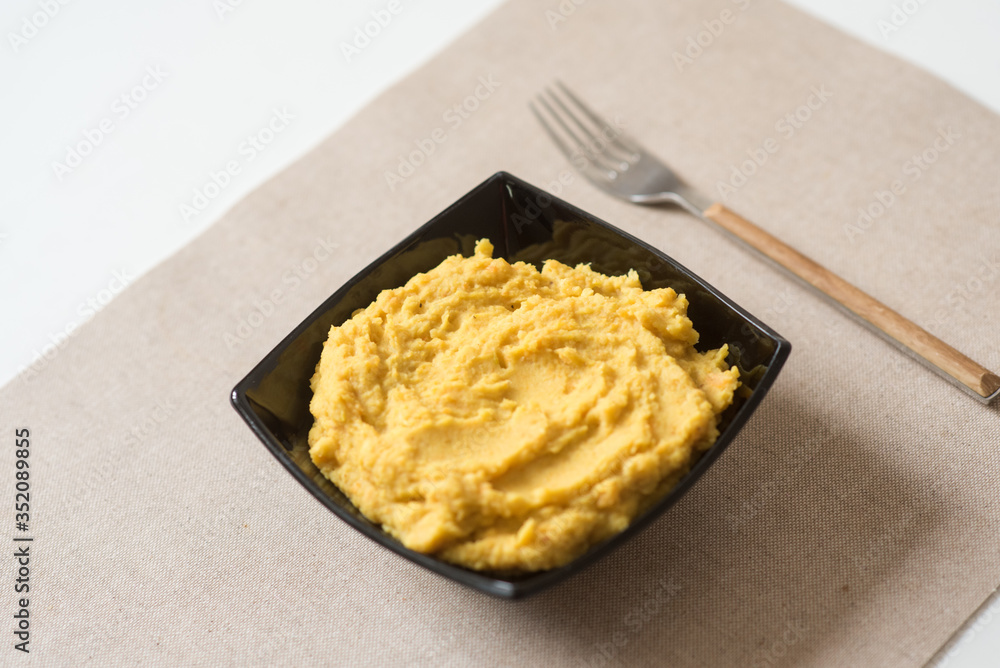 Making hummus and tahini at home. Black ceramic plate Making hummus and tahini at home. Black ceramic plate