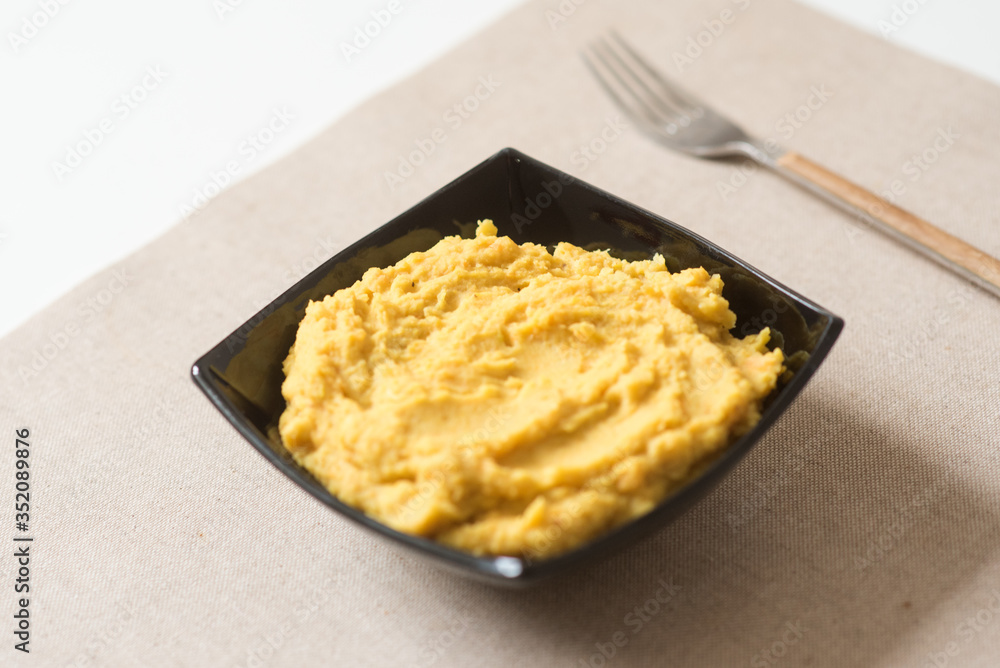 Making hummus and tahini at home. Black ceramic plate Making hummus and tahini at home. Black ceramic plate