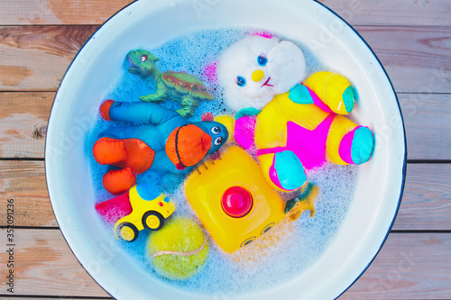 washing various toys with soap and water to disinfect them