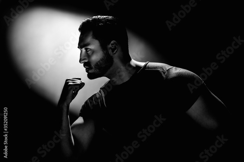 Photos Young muscular handsome minded man, black and white photo