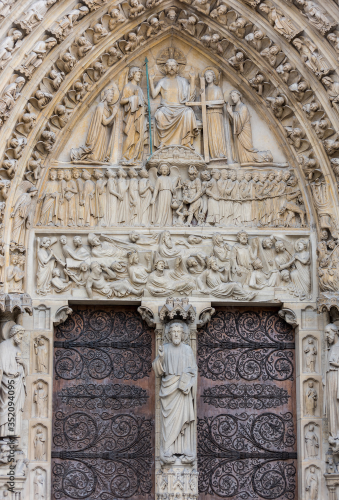 Statue on the door of Notre-Dame de Paris before the big fire, a medieval Catholic cathedral on the Ile de la Cite in the 4th arrondissement of Paris.