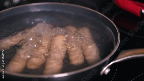 Boil sausage in a frying pan/Cooking wiener sausage/Getting ready for dinner