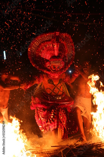 KANDANAR KELAN THEYYAM
THEYYAM - HUMAN GOD OF MALABAR THEYYAM IS AN TRADITIONAL ART FORM USUALLY PLAYS ON TEMPLES OF MALABAR WHICH EXICTED IN KANNUR AND KASARAGOD DISTRICTS OF KERALA STATE IN INDIA photo