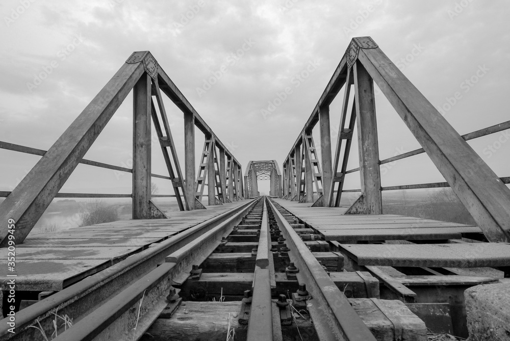 Iron railway bridge crosses the river