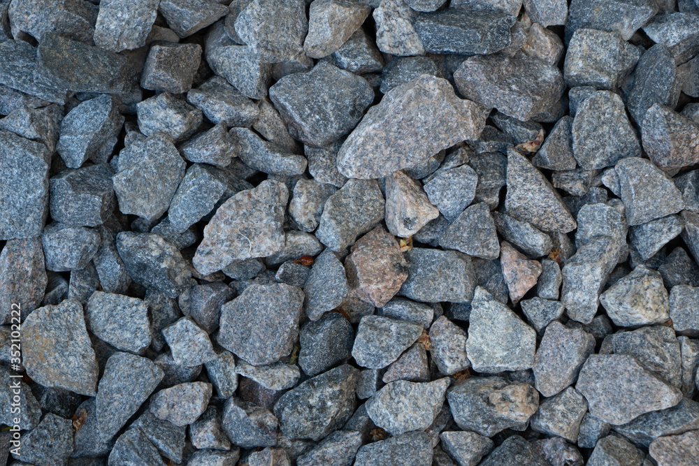 Large parts of crushed stones on the ground texture