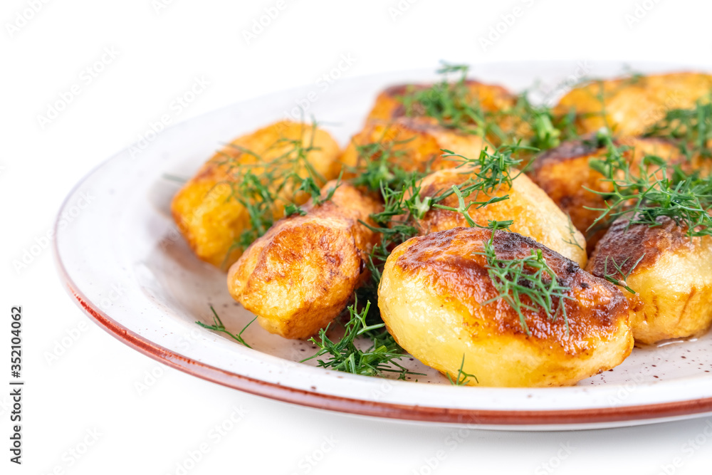Fried fresh potatos and dill on a plate isolated on a white background Fried fresh potatos and dill on a plate isolated on a white background