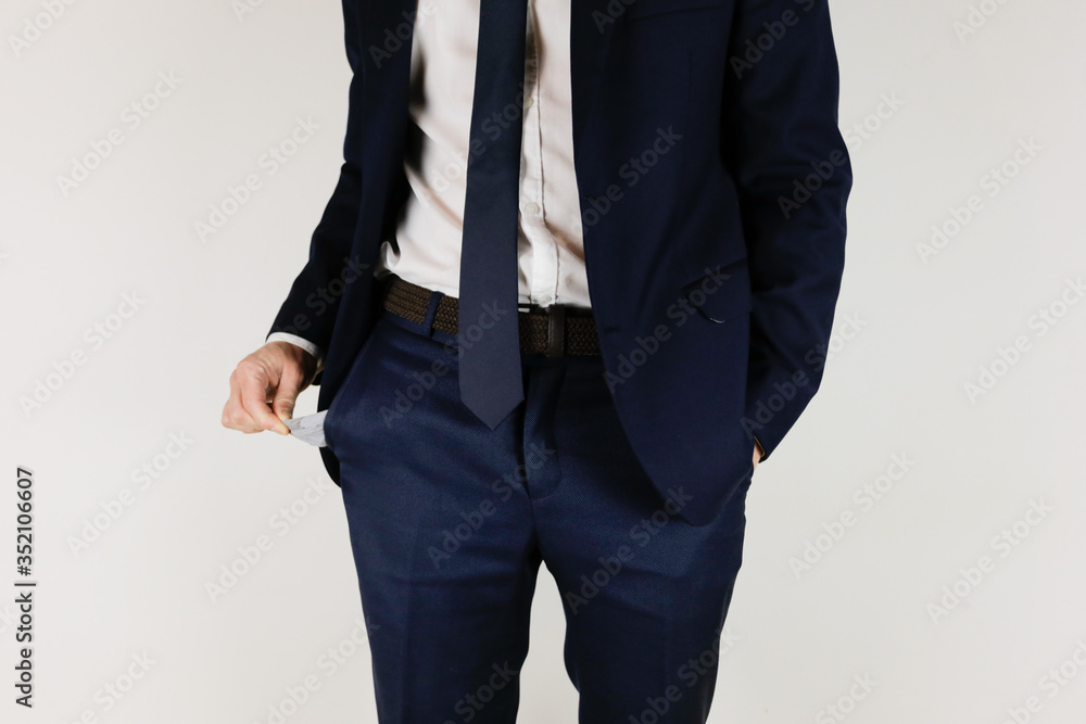 A man in a business suit turned his pockets inside out. Financial crisis. Bankruptcy in business. An entrepreneur without money. A man in a business suit turned his pockets inside out. Financial crisis. Bankruptcy in business. An entrepreneur without money.