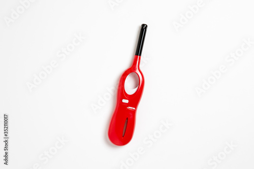 Red Gas lighter gun for gas stove, candles, campfire and barbecue isolated on white background.Lighter for kitchen. High-resolution photo.