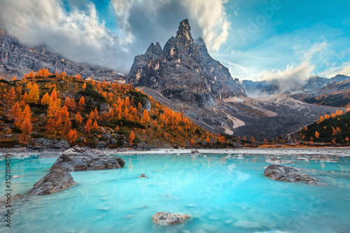 Autumn alpine landscape with turquoise glacier lake, Sorapis, Dolomites, Italy
