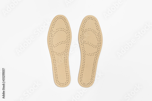Leather insoles for shoes isolated on white background.High-resolution photo.Perspective view.
