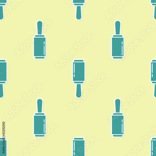 Green Adhesive roller for cleaning clothes icon isolated seamless pattern on yellow background. Getting rid of debris, dust, hair, fluff, pet wool. Vector