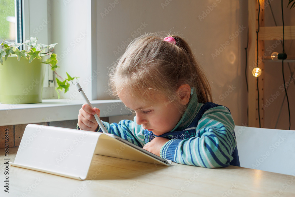 Little girl with tablet and stylus learning drawing online Little girl with tablet and stylus learning drawing online