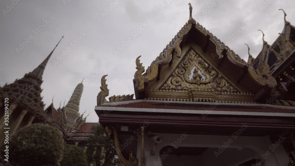 Panning shot of famous Buddhist temple buildings against sky - Bangkok, Thailand Panning shot of famous Buddhist temple buildings against sky - Bangkok, Thailand