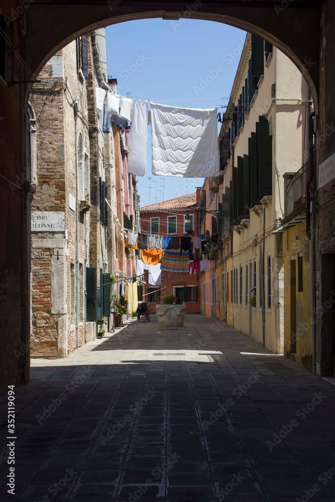 Ancient road in Venice with cloths hang out to dry