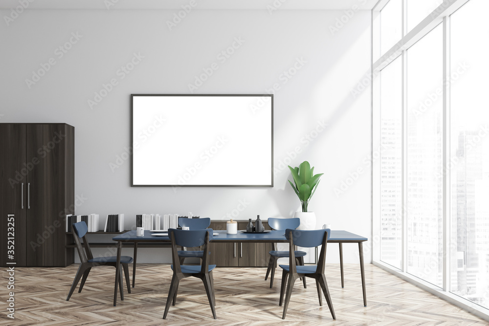 White and wood dining room, bookshelf and poster