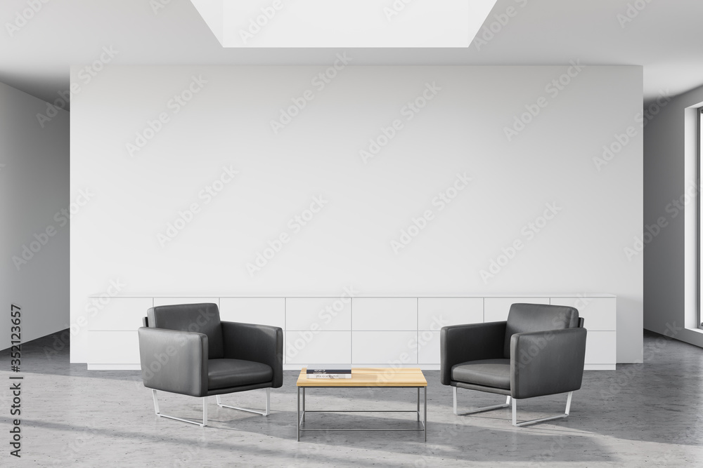 White office waiting room with grey armchairs White office waiting room with grey armchairs