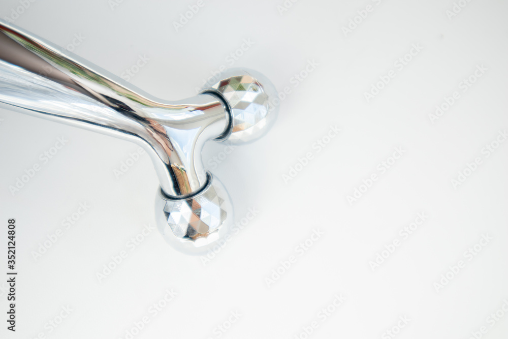 Silver Face massage roller for facial massage therapy on white background Silver Face massage roller for facial massage therapy on white background