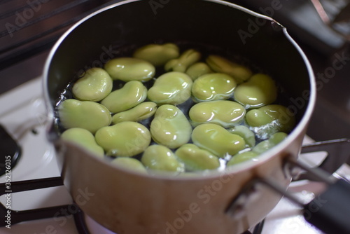 Boiling  broad bean seeds  in the pod