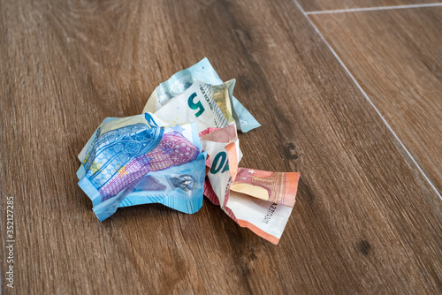 Obraz na płótnie Crumpled euro money on a wooden background. Crumpled Banknotes. w salonie