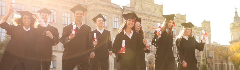 Happy students with diplomas near campus. Banner design