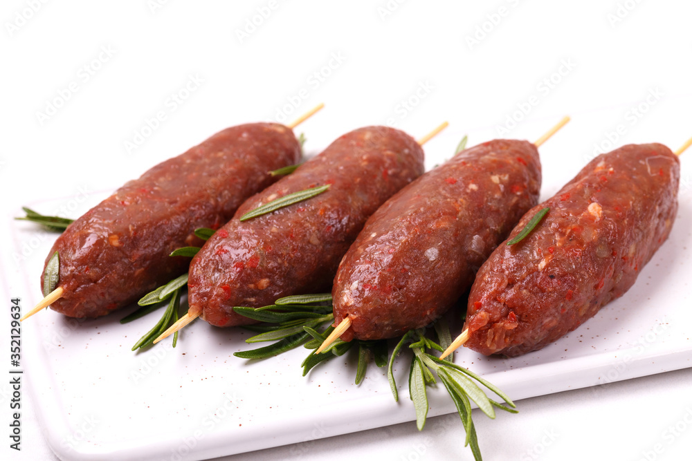 raw lula kebab, lyulya-kebab minced meat. ready to cook with rosemary. Fast food raw lula kebab, lyulya-kebab minced meat. ready to cook with rosemary. Fast food