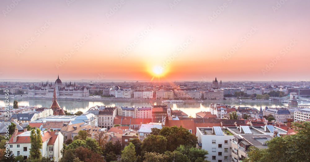 Panoramic cityscape of Hungarian parliament building and Saint Stephen basilica on the Danube river. Colorful sunrise in Budapest, Hungary