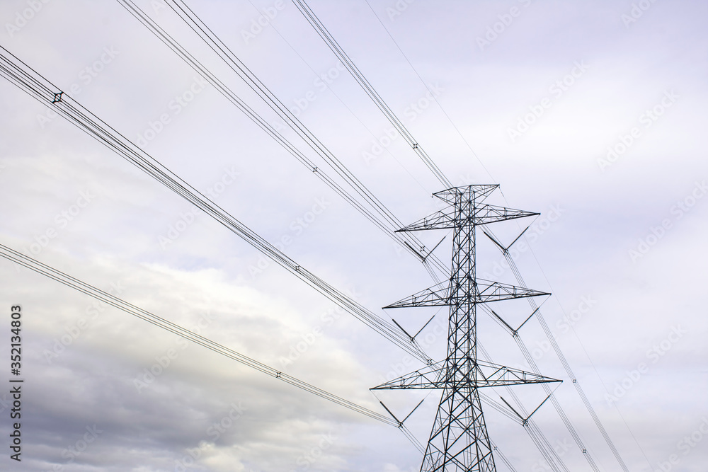 Electricity pole with silhouette sunset sky, Electricity pylon with shadow of tree in dawn time, Electricity pylon on orange sky Electricity pole with silhouette sunset sky, Electricity pylon with shadow of tree in dawn time, Electricity pylon on orange sky