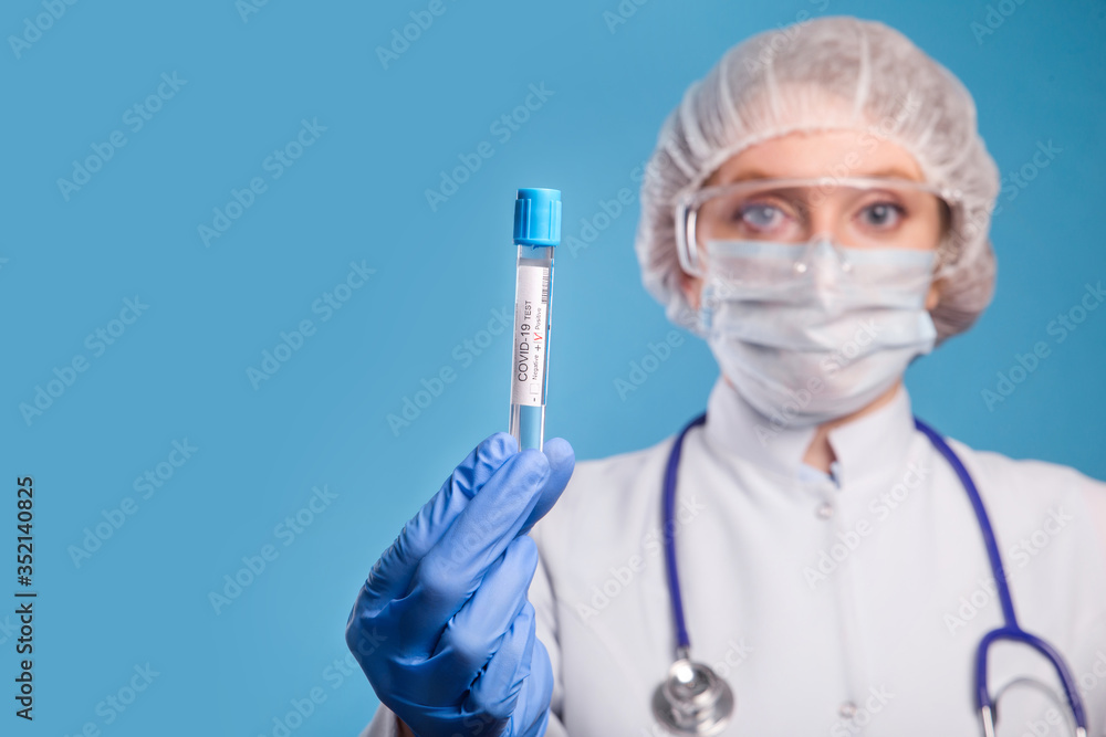 Doctor wearing protective mask holding a positive blood test result for the Coronavirus. Covid-19 test