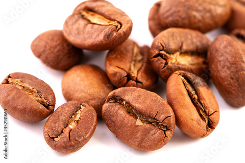 group of isolated roasted coffee beans, close up. 
