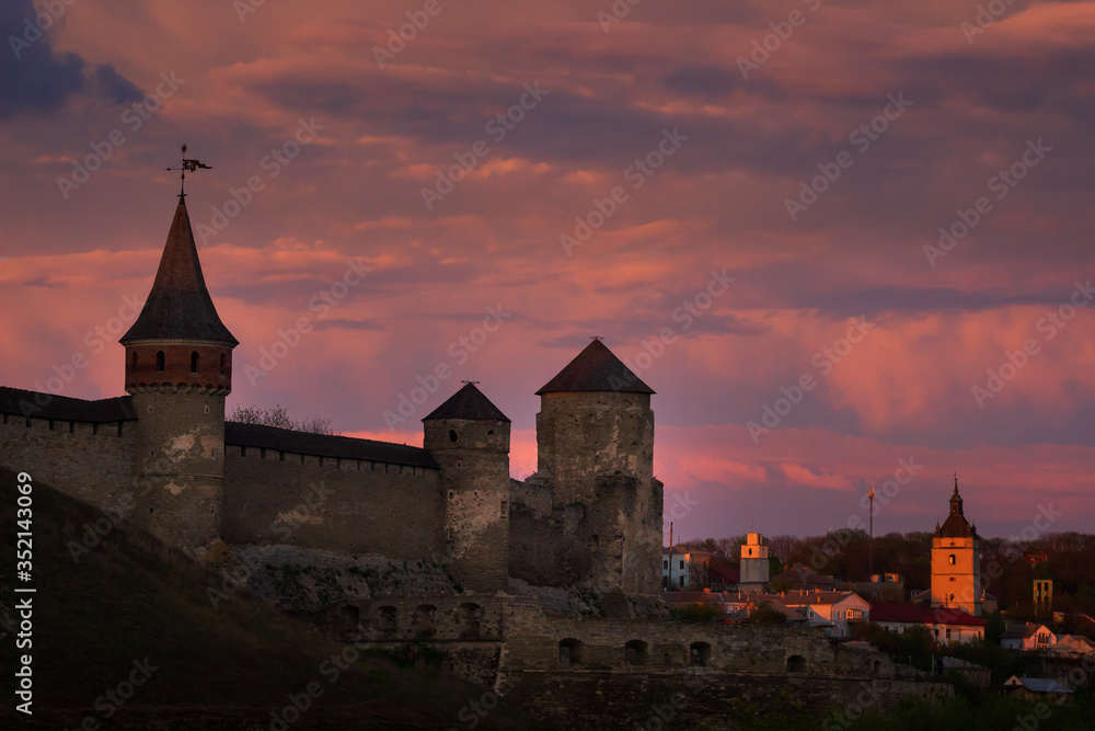 Sunset view on the castle in Kamianets-Podilskyi in spring.