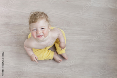 beautiful baby in the room is playing with mom, a red-cheeked child.