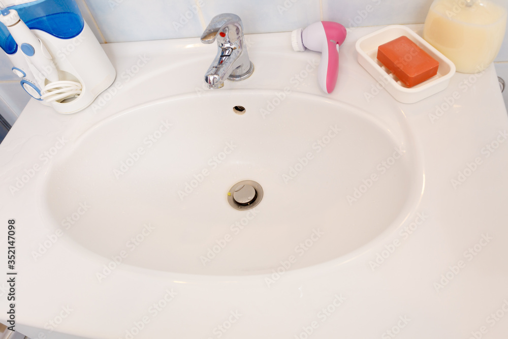 Fototapeta premium bathroom sink tap, soap bar and liquid