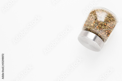 Set of Italian herbs seasoning in a jar on a white background with copyspace